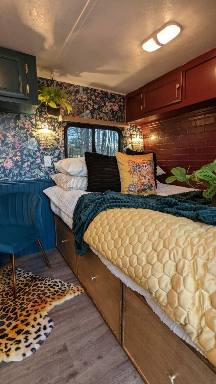 a bed sitting inside of a bedroom on top of a wooden floor next to a window