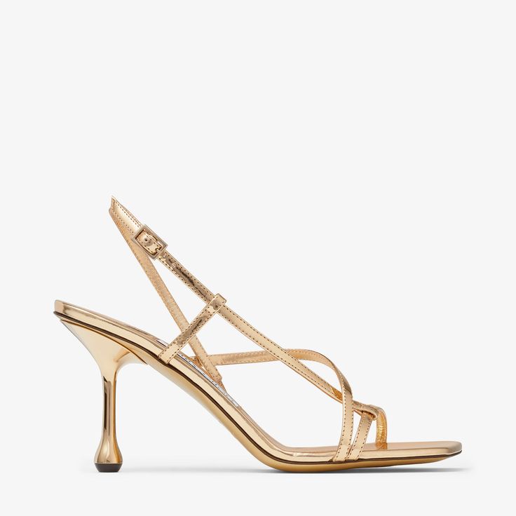 A sculptural design with a graphic drop heel, the Etana sandal is modern update to a wardrobe classic. Crafted from leather with a metallic finish, this statement design features crossover straps and an adjustable fastening. Jimmy Choo Gold, Jimmy Choo Heels, Monk Strap Shoes, Wardrobe Classic, Leather Lingerie, Jimmy Choo Shoes, Footwear Design Women, Fine Jewelry Designers, Color Dorado