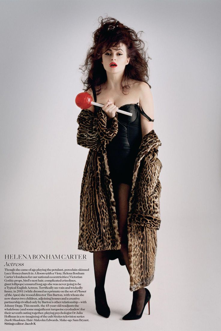 a woman in a leopard print coat holding a lollipop