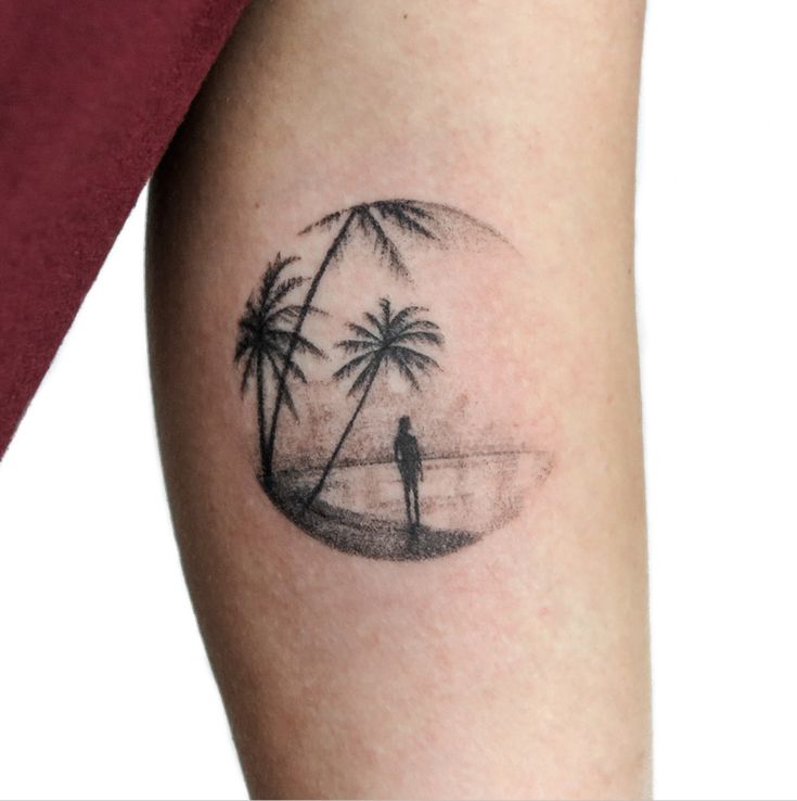 a man with a palm tree tattoo on his arm