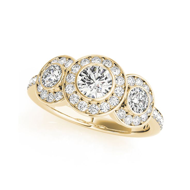 a yellow gold ring with three round diamonds on the band and an oval center stone