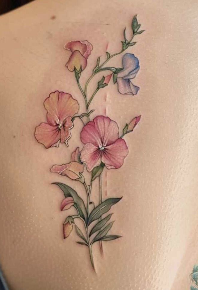 a woman's back with flowers on it