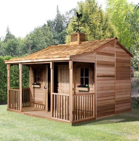 a small wooden shed sitting on top of a lush green field