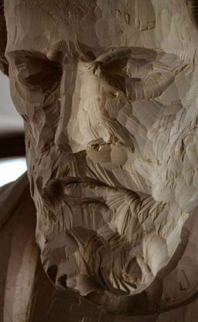 a close up of a sculpture of a man's face