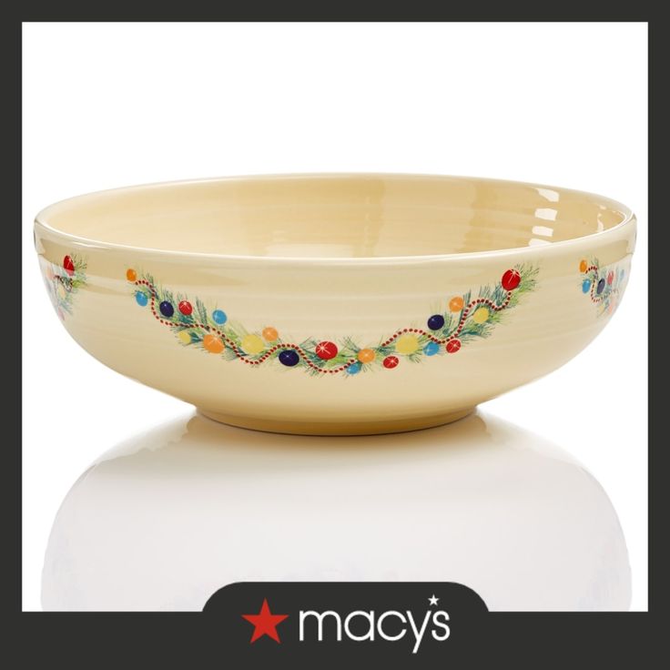 the bowl is decorated with colorful flowers and beads on it's rim, which matches the rest of the bowl