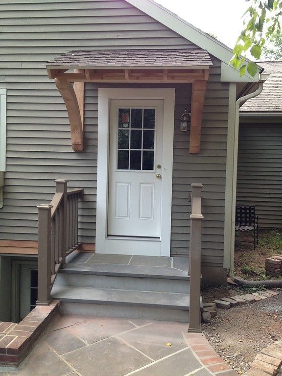 a house with a white front door and steps leading up to the entryway area