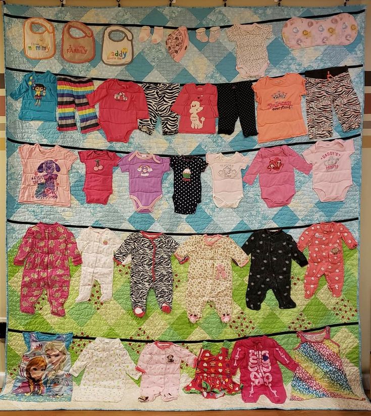 there are many baby ones hanging on the clothes line in front of each other,