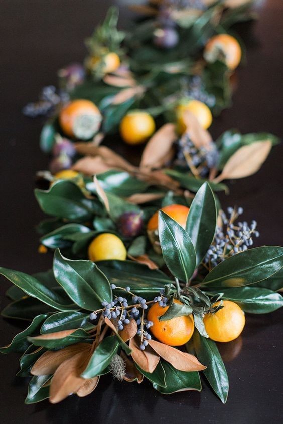 oranges and leaves are arranged on the table