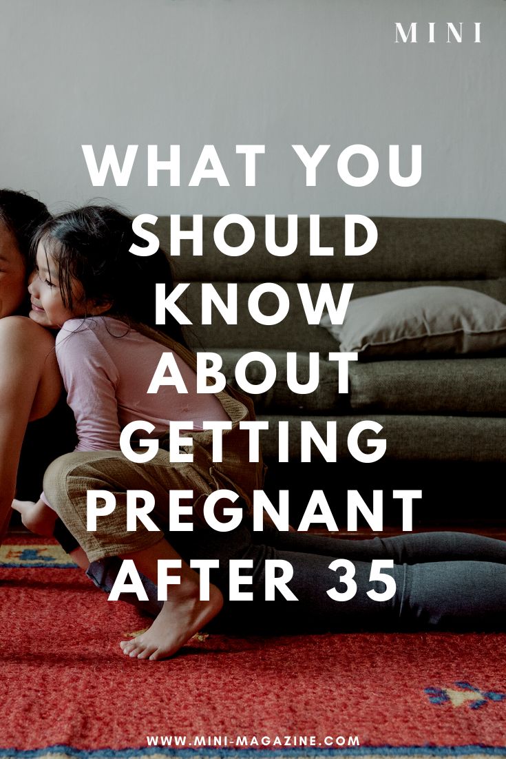 two children sitting on the floor with their arms around each other and text that reads, what you should know about getting pregnant after 35