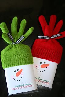 two small christmas gifts wrapped in green and red paper with snowman faces on them