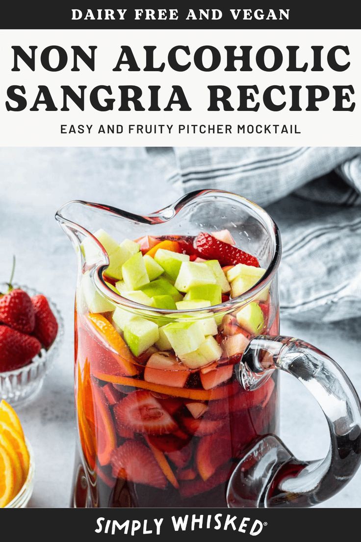 a pitcher filled with fruit sitting on top of a table