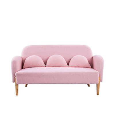 a pink couch sitting on top of a white floor