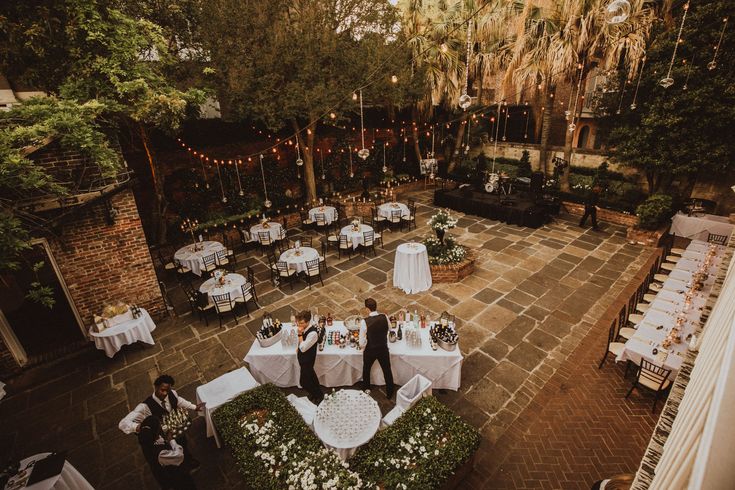 an aerial view of a wedding reception in the courtyard