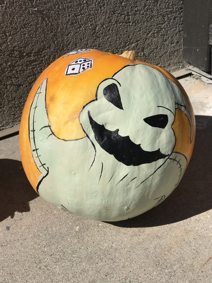 a painted rock sitting on the ground next to a building