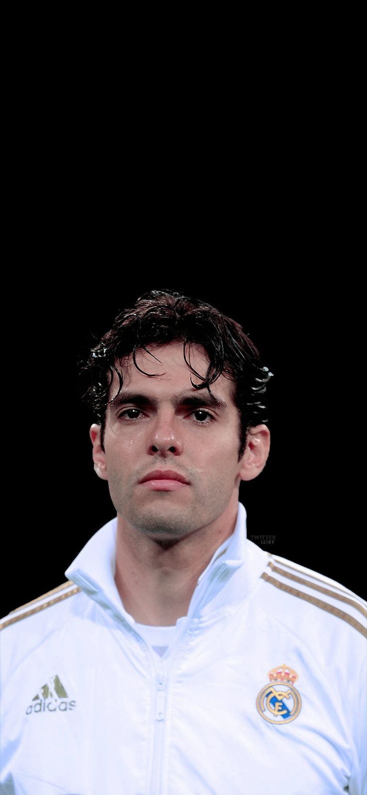 a man in a white jacket looking at the camera with a serious look on his face