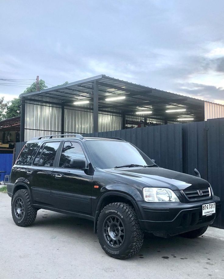 a black suv parked in front of a building