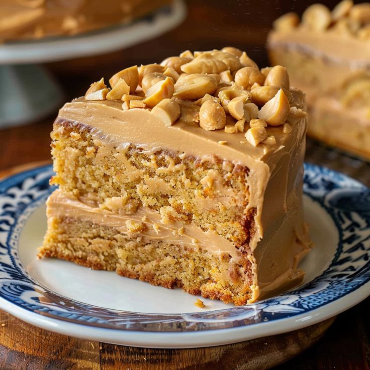 a piece of cake on a plate with peanut butter frosting and nuts in the middle