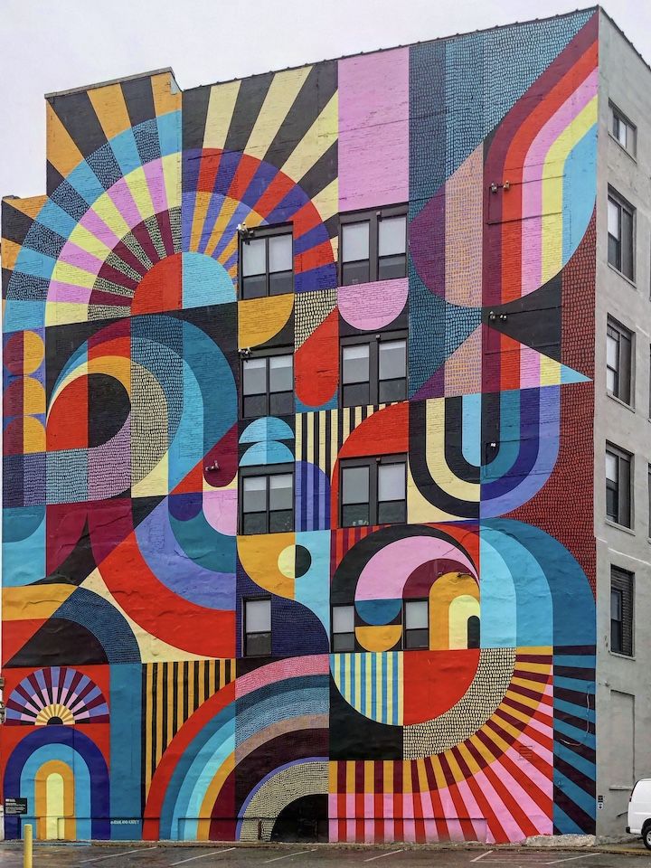 a large colorful mural on the side of a building