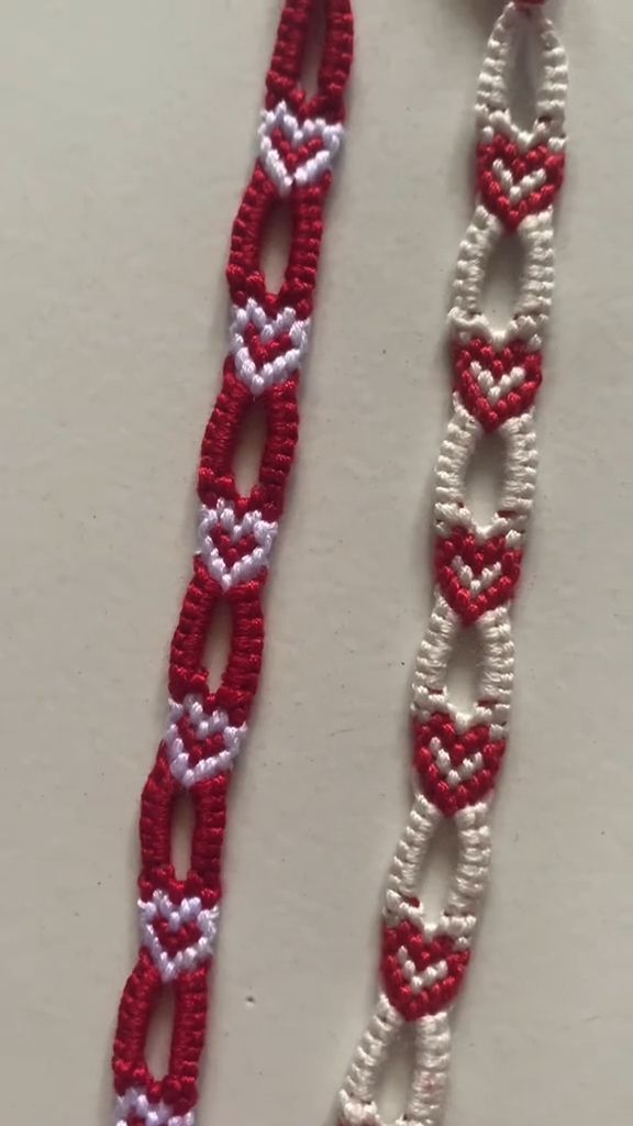 two red and white bracelets with hearts on them