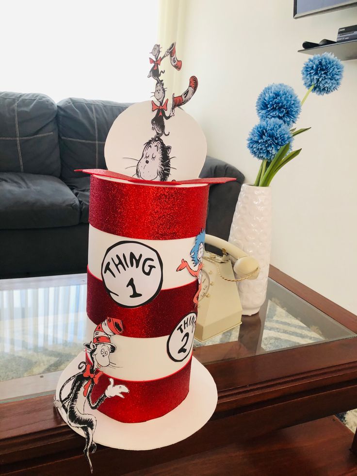 a dr seuss hat with the cat in the hat on it and some blue flowers