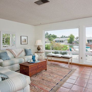 a living room filled with furniture next to a large sliding glass door that opens onto a patio