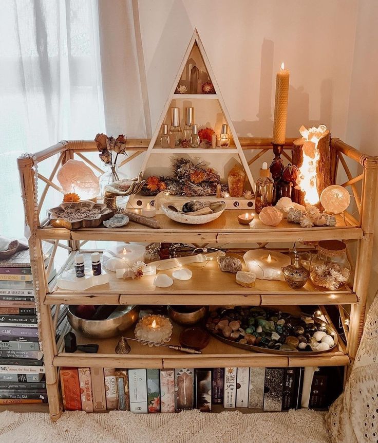 a shelf filled with books and candles on top of a rug next to a window