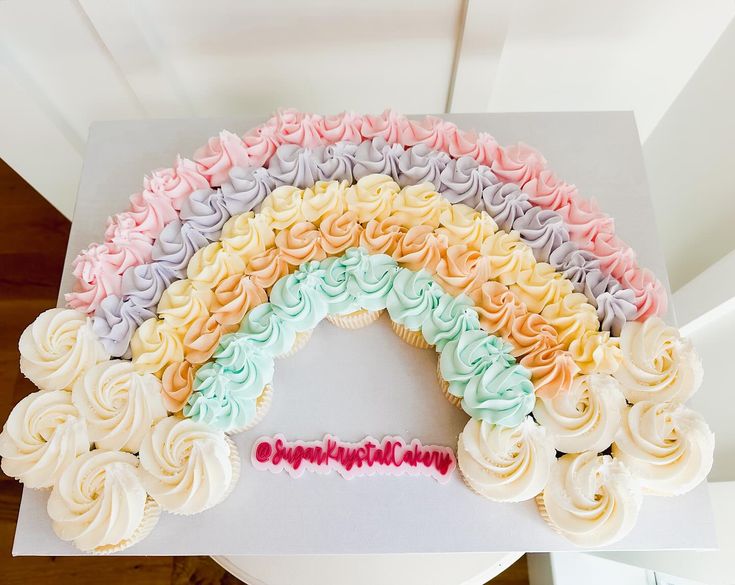 a rainbow shaped cupcake on top of a white box