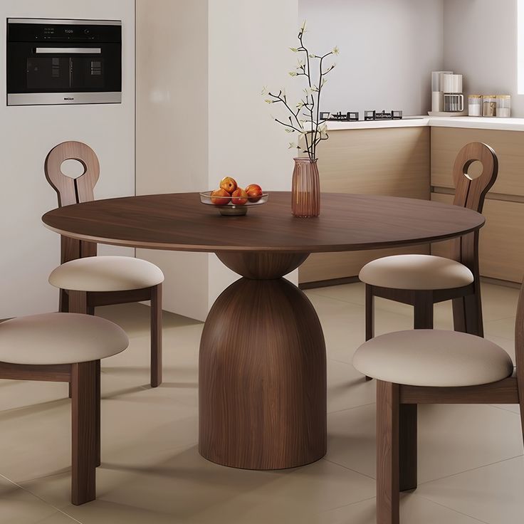 a table with four chairs around it in a room that has white tile flooring