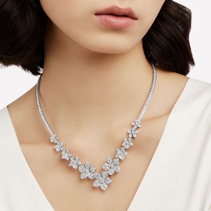 Tracing a delicate V shape upon the décolletage, our white gold Wild Flower diamond necklace is beautifully articulated to bloom with an irresistible beauty. Featuring a sequence of diamond flowers that ascend in size, every last petal is uniquely realised to burst with life. The Wild Flower collection is an invitation to escape into a garden that grows just for you. From trios and individual blooms to floral clusters and blossoms laid out in a row, each Wild Flower jewel is a statement of delic Large Diamond Stud Earrings, Flower Diamond Necklace, Triple Diamond Ring, Large Diamond Rings, Heart Shaped Diamond Pendant, Rare Diamonds, Diamond Drop Pendant, Round Diamond Pendant, Pear Shaped Diamond Ring