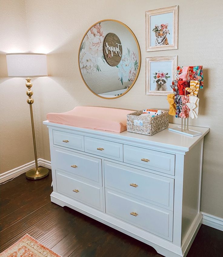 a baby crib in the corner of a room with pictures on the wall above it