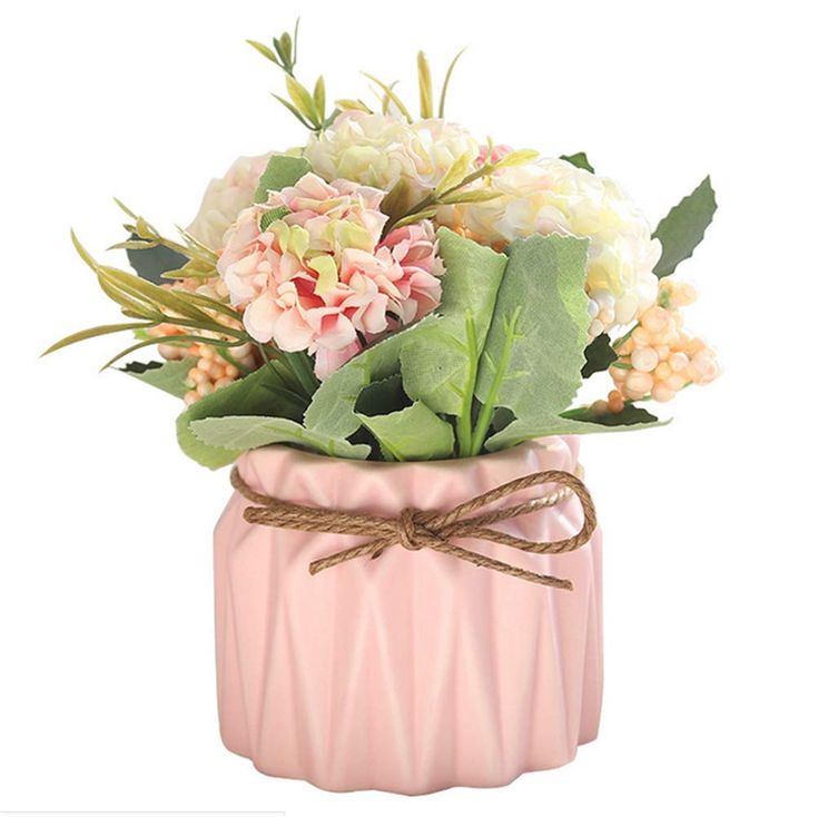 a pink vase filled with lots of flowers