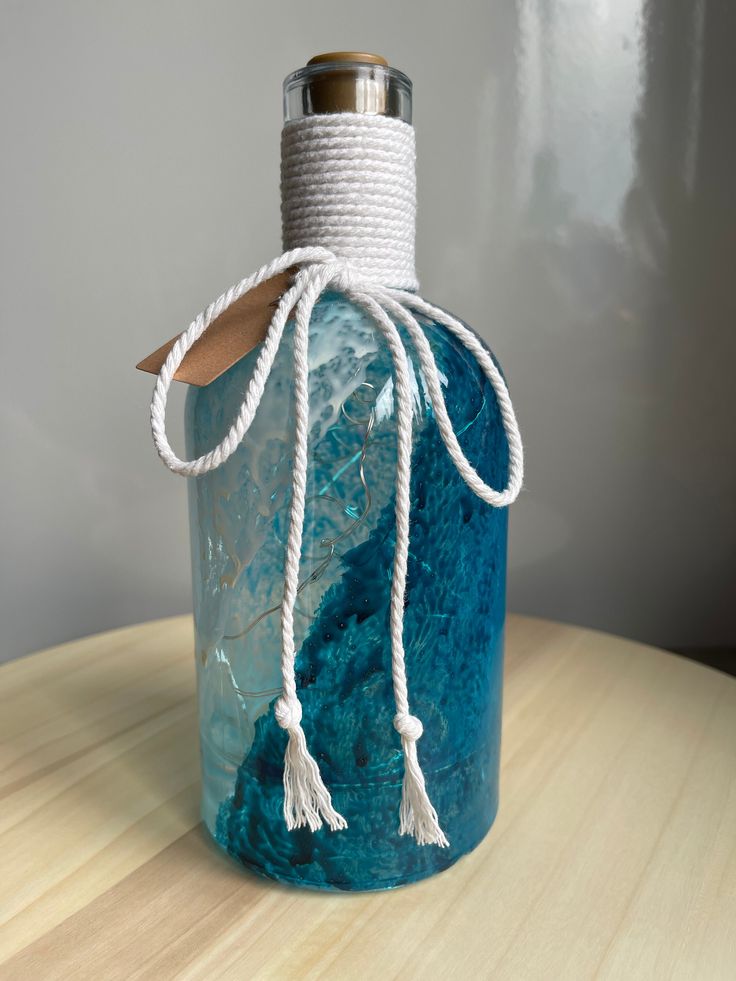 a blue bottle with rope wrapped around it