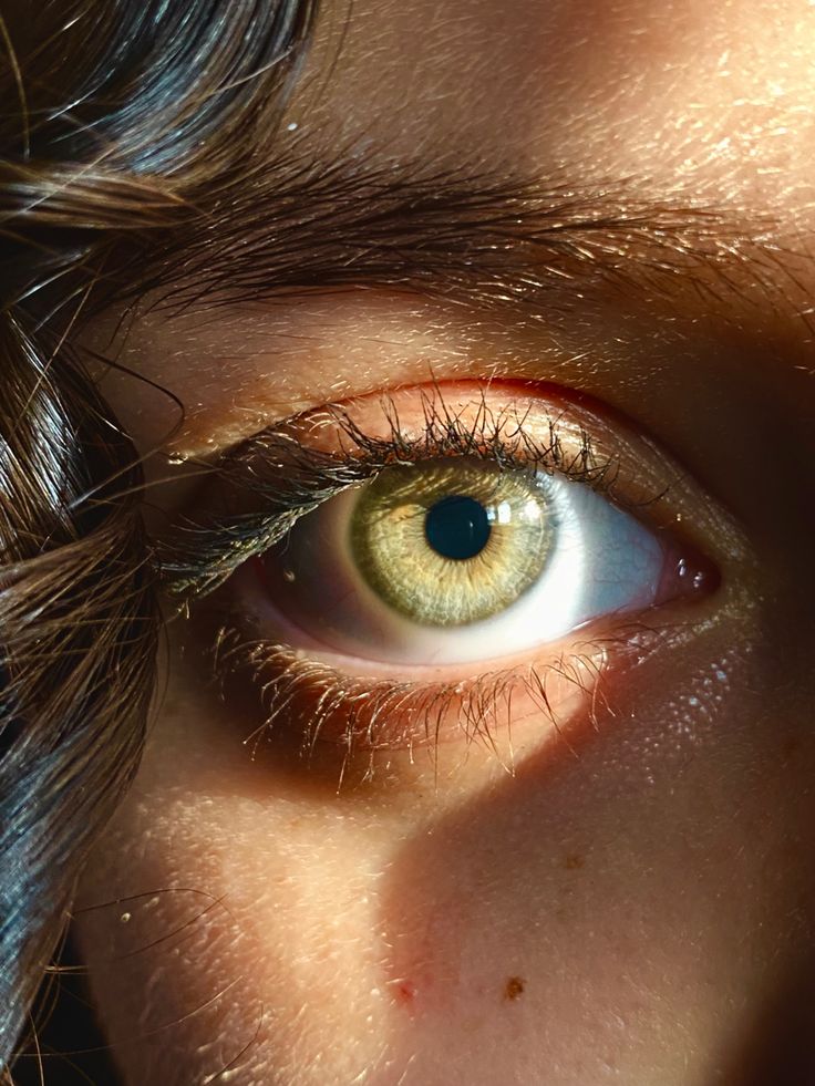 an image of a person's eye with long hair