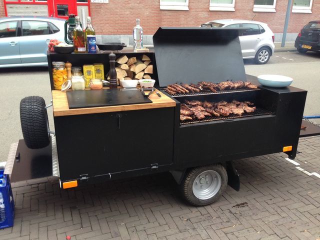 an outdoor bbq grill with food on it