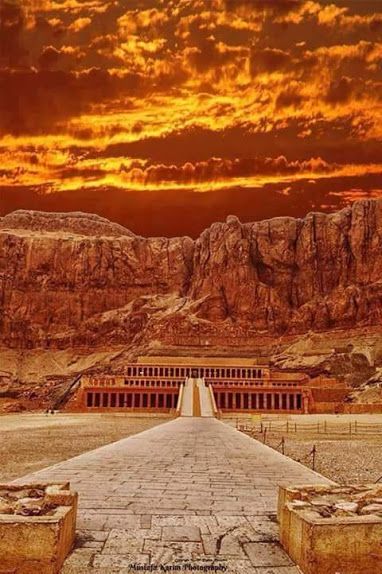 the entrance to an ancient city with mountains in the background