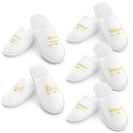 six white slippers with gold lettering on them