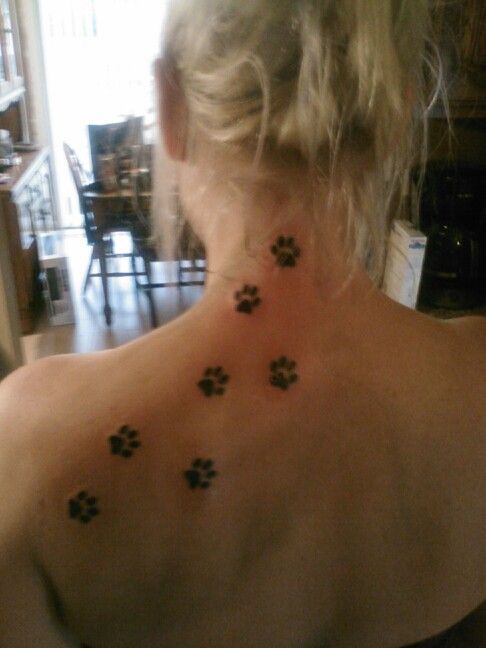 the back of a woman's neck with paw prints on it