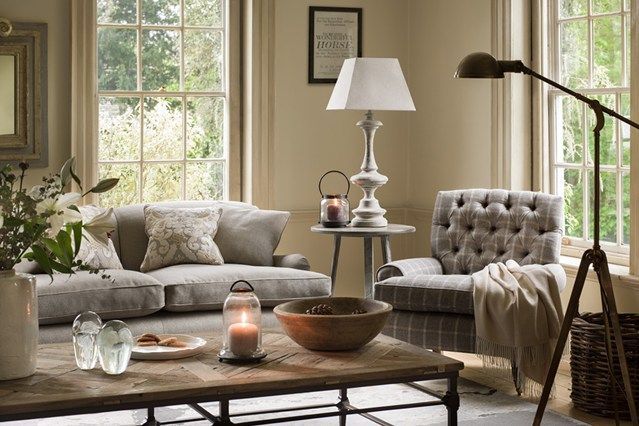 a living room with two couches and a coffee table in front of the window