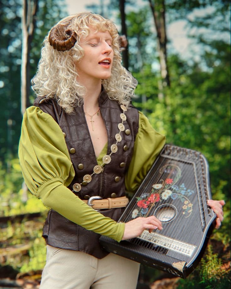 a woman holding a tray with an animal on it's head and wearing a costume