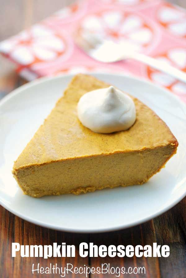 a piece of pumpkin cheesecake on a white plate with whipped cream in the middle