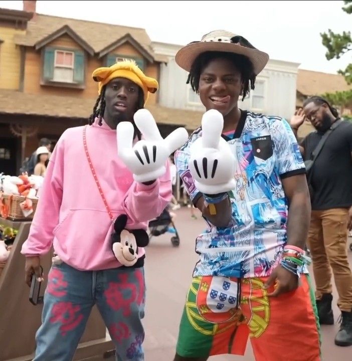 two men in mickey mouse costumes standing next to each other