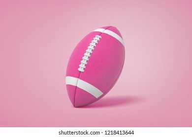 an american football on a pink background