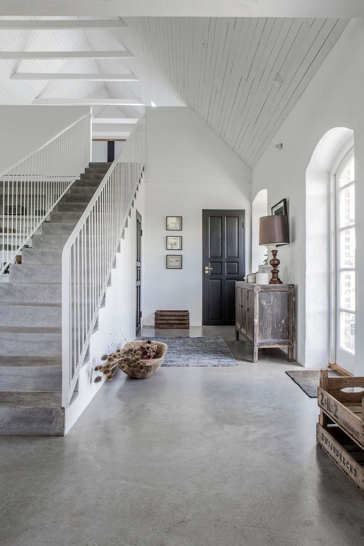 an empty room with stairs leading up to the second floor