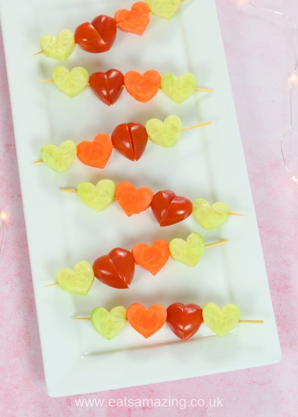 heart shaped candy lollipops on a white plate