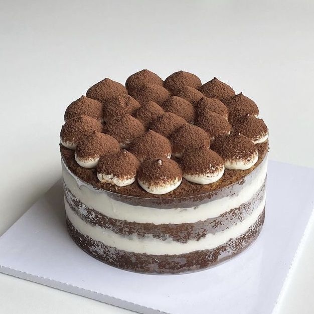 a chocolate cake with white frosting on top