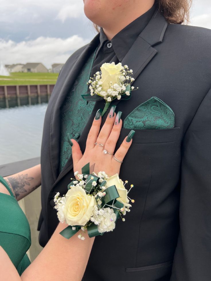 a man in a suit and woman with flowers on their hands