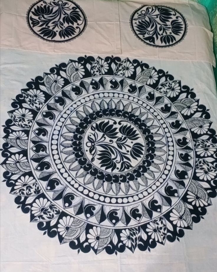 a black and white bedspread with an intricate design on it