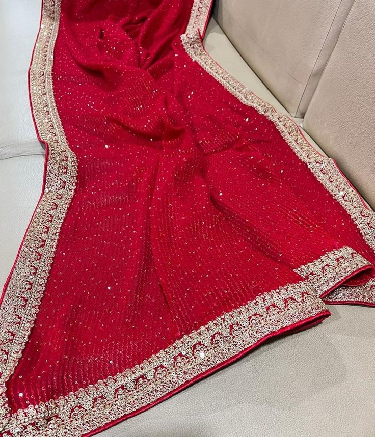 A beautiful bright red saree with a hint of glamour  on a sheer and dreamy drape! In this sequin embellished all over the body georgette saree , you are going to have all eyes on you!  A sheer body with a soft drape, the sequins stripes make it trendier! Beautiful crafted border snd pally makes it more gorgeous.  The saree comes with an unstitched blouse piece with full sequins work. It is ready to wear with falls and pico done ( complimentary).  Note: Product color may slightly vary due to photographic lighting sources or your device settings.  Note : Please leave your phone no and email id for shipping purpose , without this I can't ship it as DHL EXPRESS needs . Glamorous Festive Pre-draped Saree With Sheer Dupatta, Red Pre-draped Saree For Eid Wedding, Red Unstitched Pre-draped Saree For Diwali, Festive Pre-draped Saree With Dabka Work For Diwali, Traditional Georgette Pre-draped Saree For Celebration, Georgette Pre-draped Saree With Dupatta For Diwali, Diwali Party Wear Georgette Pre-draped Saree, Pre-draped Georgette Saree For Celebration, Party Wear Pre-draped Saree With Sheer Dupatta For Celebration