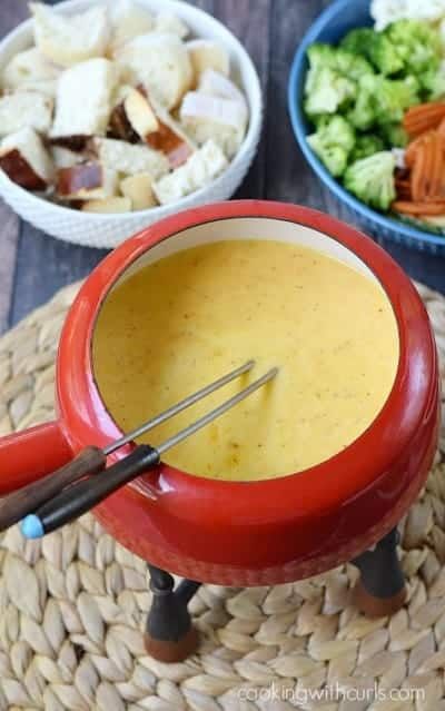 there is a bowl of soup with a whisk in it next to other bowls