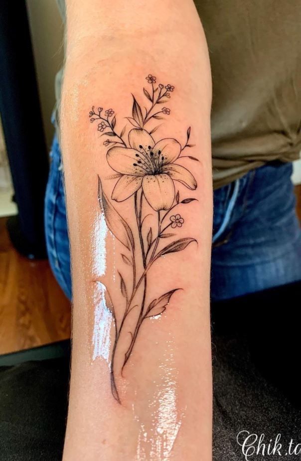 a woman's arm with a flower tattoo on the left side of her body